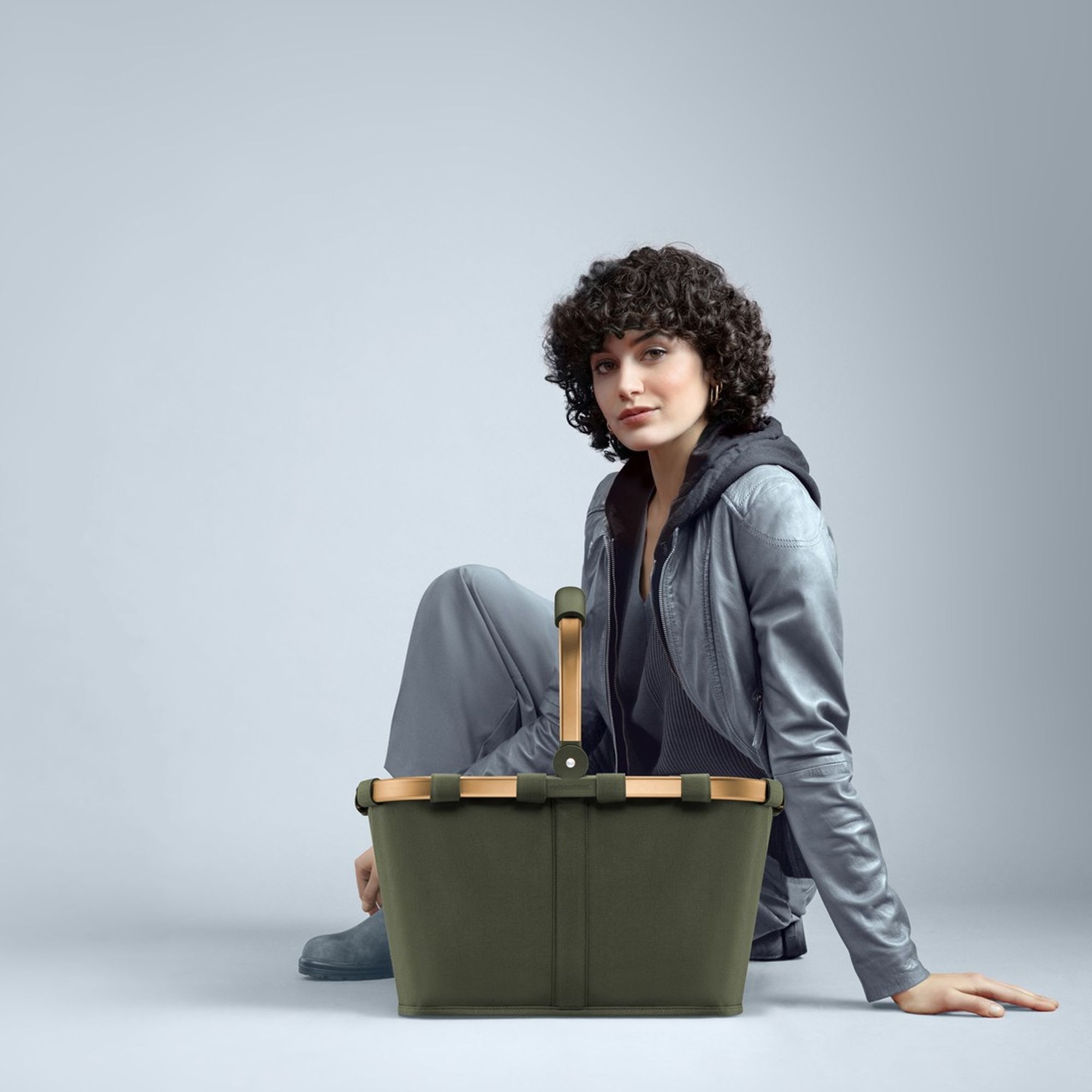 Person mit modernem olivgrünem Picknickkorb